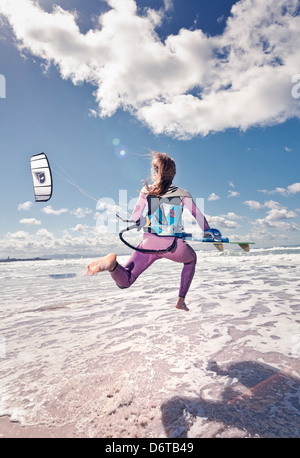 Kitesurfer running into the sea. Tarifa, Costa de la Luz, Cadiz, Andalusia, Spain, Europe. Stock Photo