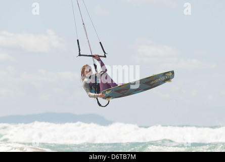 Woman in mid air gliding from her kite. Tarifa, Costa de la Luz, Cadiz, Andalusia, Spain, Europe. Stock Photo