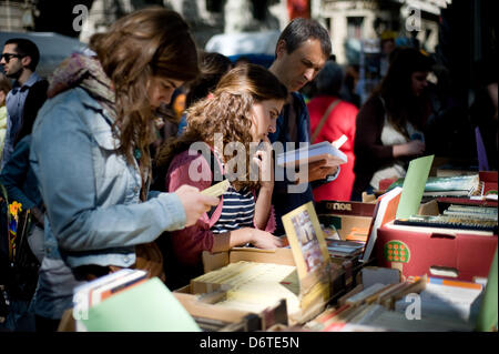 La Rambla, Barcelona, Spain. 23rd April, 2013. People looking at books.The traditional day of Sant Jordi was held this morning at the Rambla of Barcelona between books roses and a nice spring weather. Credit: Jordi Boixareu/Alamy Live News Stock Photo