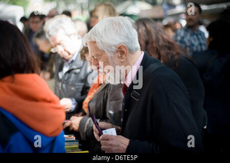 La Rambla, Barcelona, Spain. 23rd April, 2013. People looking at books. The traditional day of Sant Jordi was held this morning at the Rambla of Barcelona between books roses and a nice spring weather. Credit: Jordi Boixareu/Alamy Live News Stock Photo