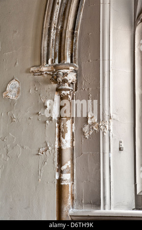 Damaged and rotting plaster in a Victorian church caused by water penetration from a leaking gutter (UK) Stock Photo