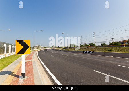 Road Sign warns Drivers to Beware Ahead Dangerous Curve. Stock Photo