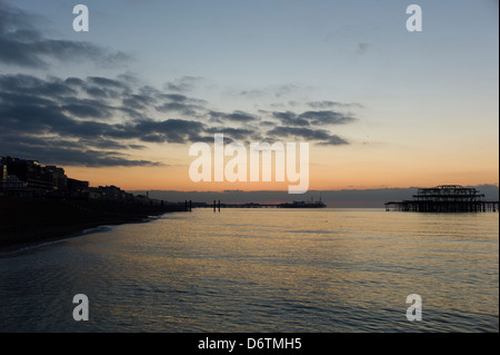 Sunrise over Brighton seafront and piers Stock Photo