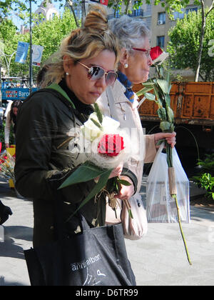 Barcelona, Spain. April 23rd 2013. Sant Jordi 2013: Saint George's festivities  held in Barcelona on April 23rd. Women with roses.Credit: Monica Condeminas/Alamy Live News Stock Photo