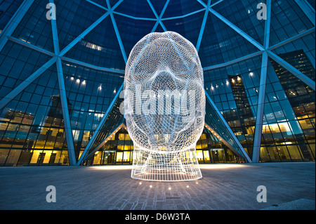 Bow Building in downtown Calgary with the wire head sculpture entitled Wonderland installed at the entrance Stock Photo