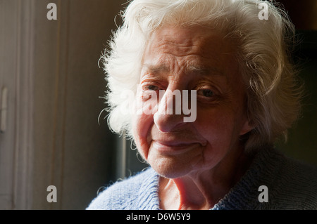 Portrait of old woman smiling and looking at the camera. Close view. Stock Photo