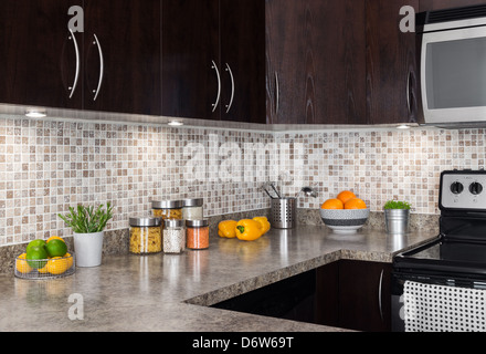 Modern kitchen with cozy lighting, and food ingredients on the counter top. Stock Photo