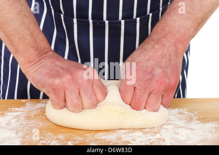 Pair of male hands kneading bread dough on a kitchen worktop Stock Photo