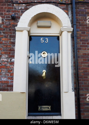 Victorian entrance with copper doorknocker, letterbox and spyhole in Manchester UK Stock Photo