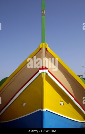 A traditional Maltese fishing boat called Luzzu known for its bright ...