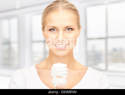 woman holding energy saving bulb Stock Photo