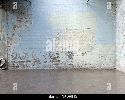old painted pale blue brick wall distressed Stock Photo