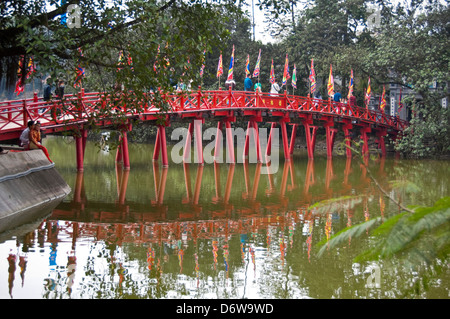 Horizontal wide angle view of The Huc bridge, Thê Húc bridge crossing Hoan Kiem Lake in Hanoi. Stock Photo
