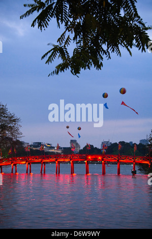 Vertical wide angle view of The Huc bridge, Thê Húc bridge crossing Hoan Kiem Lake in Hanoi at night.