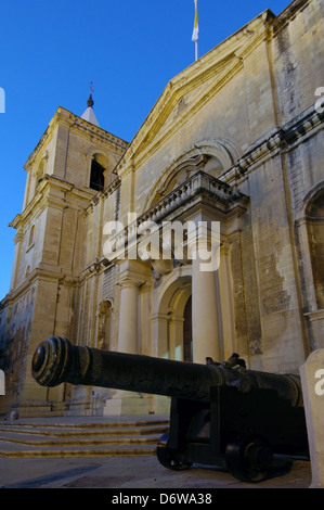 Cannon in front of the 17th century Roman Catholic St John's Co-Cathedral dedicated to Saint John the Baptist in Valletta the capital city of Malta island Stock Photo