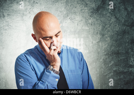 Businessman worry. Young adult bald businessman having problems. Stock Photo