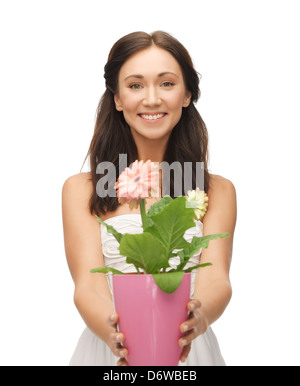 lovely housewife with flower in pot Stock Photo