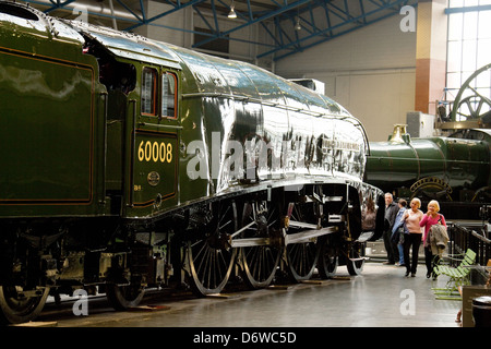 People looking at an A4 class steam engine in the National Railway Museum, York, UK Stock Photo