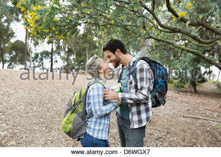 Side view of couple rubbing noses at park