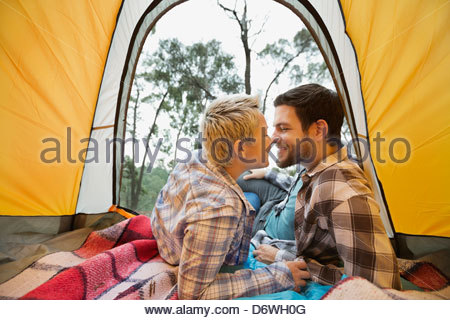 Couple rubbing noses in tent