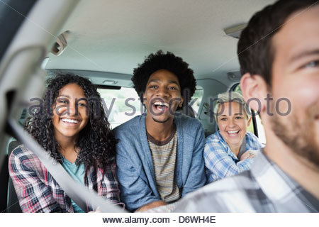 Portrait of happy teenage girl enjoying road trip with friends in truck Portrait of happy teenage girl enjoying road trip with friends in truck