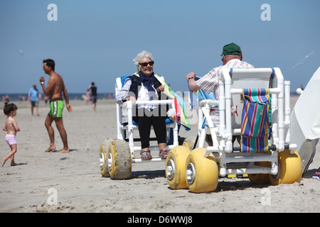 Sankt Peter-Ording, Germany, seniors in Strandrollstuehlen on the beach of St. Peter-Ording Stock Photo