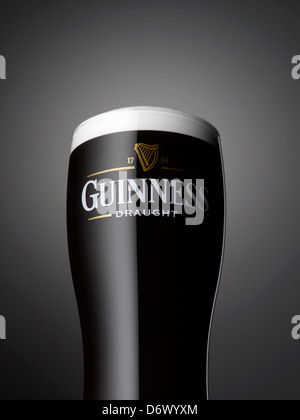 A close up shot of a pint of Guinness on a grey background
