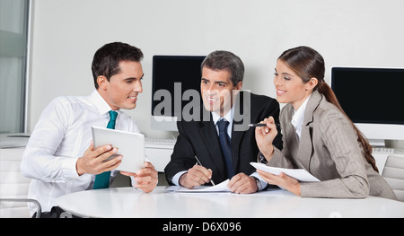 Businesspeople at a meeting with tablet computer in the office Stock Photo