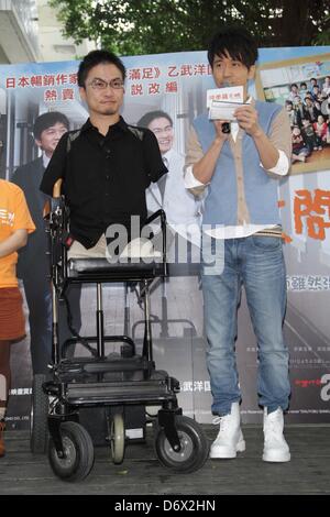 Japanese writer Hirotada Ototake and Chinese singer Michael Wong shared positive spirits with school kids in Taipei, Taiwan, China on Tuesday April 23, 2013. Stock Photo