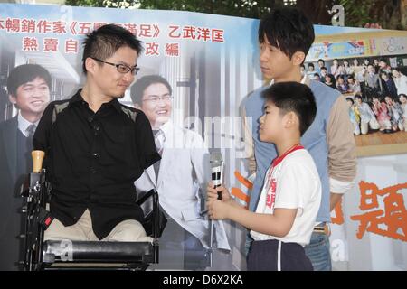 Japanese writer Hirotada Ototake and Chinese singer Michael Wong shared positive spirits with school kids in Taipei, Taiwan, China on Tuesday April 23, 2013. Stock Photo