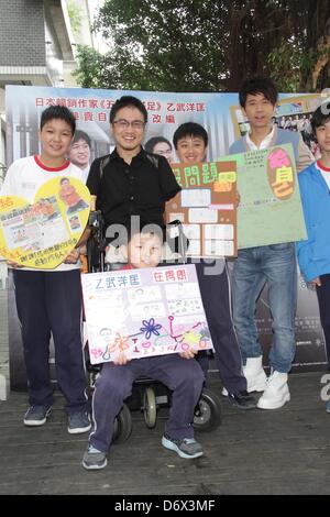 Japanese writer Hirotada Ototake and Chinese singer Michael Wong shared positive spirits with school kids in Taipei, Taiwan, China on Tuesday April 23, 2013. Stock Photo