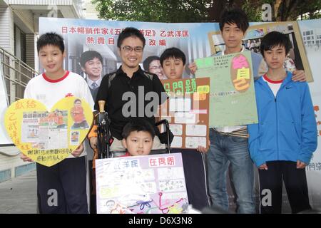 Japanese writer Hirotada Ototake and Chinese singer Michael Wong shared positive spirits with school kids in Taipei, Taiwan, China on Tuesday April 23, 2013. Stock Photo