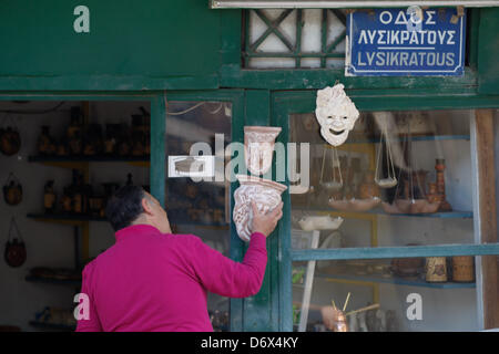 April 24, 2013 - Athens, Greece - A man open his souvenir shop with theatrical masks in old district of Athens, Plaka. (Credit Image: © Aristidis Vafeiadakis/ZUMAPRESS.com) Stock Photo