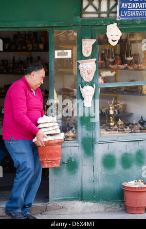 April 24, 2013 - Athens, Greece - A man open his souvenir shop with theatrical masks in old district of Athens, Plaka. (Credit Image: © Aristidis Vafeiadakis/ZUMAPRESS.com) Stock Photo