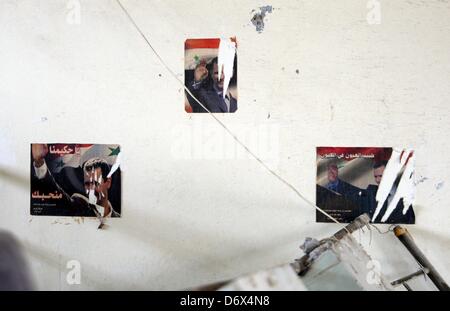 Darkoush, Syria. April 23, 2013. Three photographes of  Bashar Al-Assad in a cell in the central prison on Darkoush, Syria. April 23, 2013. . The prison was bombarded by fights between Al-Assad forces and Fee Army fighters three months ago. Credit: Gallo Images / Alamy Live News Stock Photo