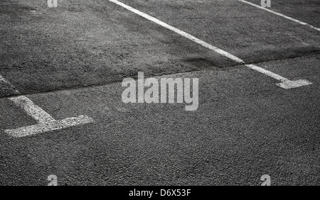 Empty parking places on dark asphalt with white lines Stock Photo