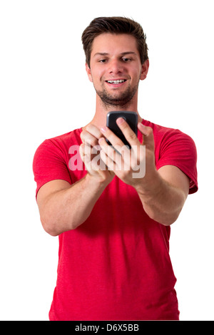 Young White Man In Red T-Shirt Working On His Smartphone Stock Photo