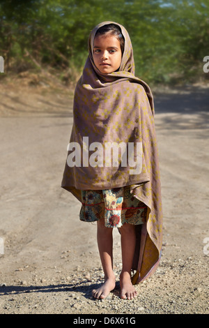 Child of India - portrait of india young small girl child standing on the road, Rajasthan State, India Stock Photo