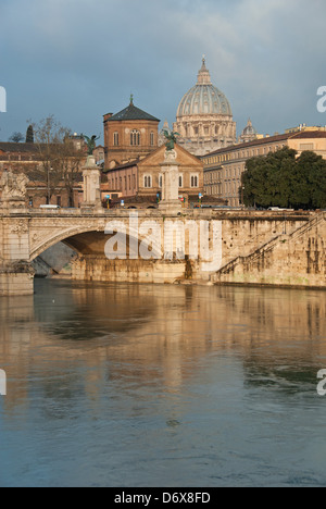 ROME, ITALY. A dawn view of the River Tiber and the Ponte Vittorio Emanuele II, with St. Peter's Basilica in the distance. 2013. Stock Photo