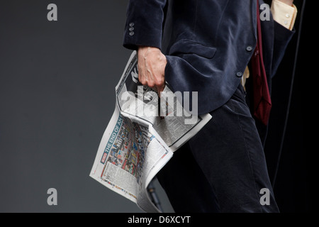 Jarvis Cocker of Pulp performing on the Main Stage, holding a copy of the last edition of The News of the World. T in the Park Stock Photo