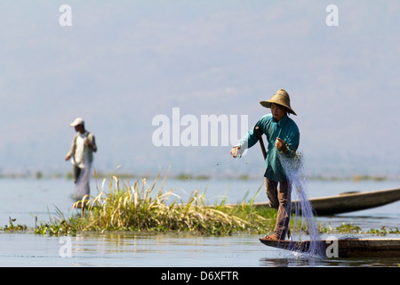Fisherman leg rowing and casting his nets on Lake Inle, Myanmar 9 Stock Photo