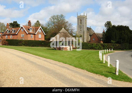 The village green and parish church of St Fabian & St Sebastian, Woodbastwick, Norfolk, England, UK Stock Photo