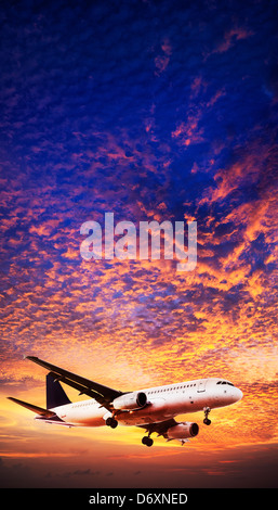 Jet is maneuvering in spectacular sunset sky Stock Photo