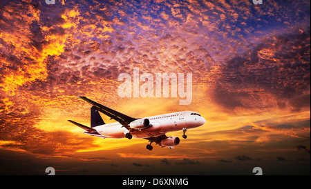 Jet is maneuvering in spectacular sunset sky Stock Photo