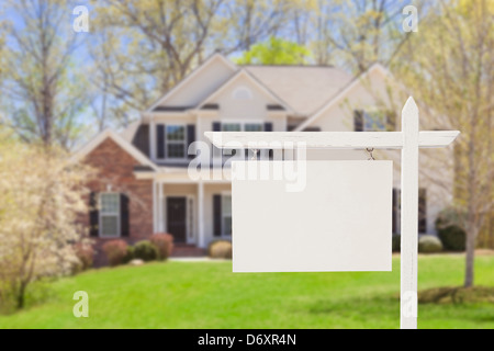 Blank Real Estate Sign in Front of Beautiful New House. Stock Photo