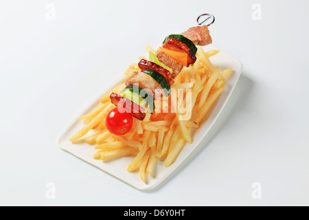 Pork and vegeable skewer with French fries Stock Photo