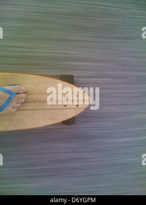 Caucasian man riding skateboard Stock Photo