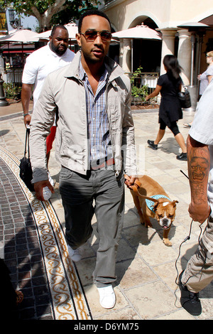 John Legend and his dog at The Grove to film an appearance with Mario Lopez for the entertainment television news programme Stock Photo