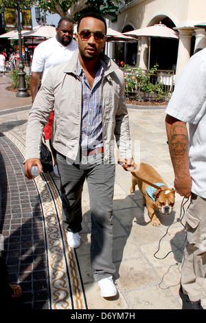 John Legend and his dog at The Grove to film an appearance with Mario Lopez for the entertainment television news programme Stock Photo