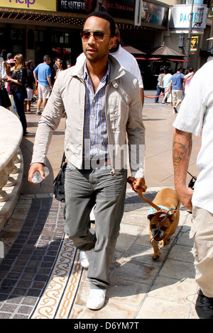 John Legend and his dog at The Grove to film an appearance with Mario Lopez for the entertainment television news programme Stock Photo